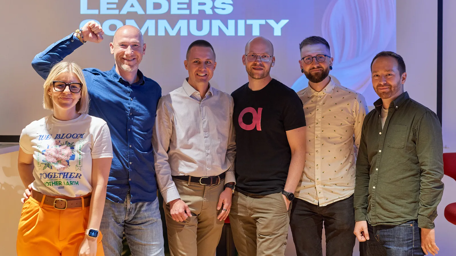 Řečníci na pódiu před stěnou Engineering Leaders Community